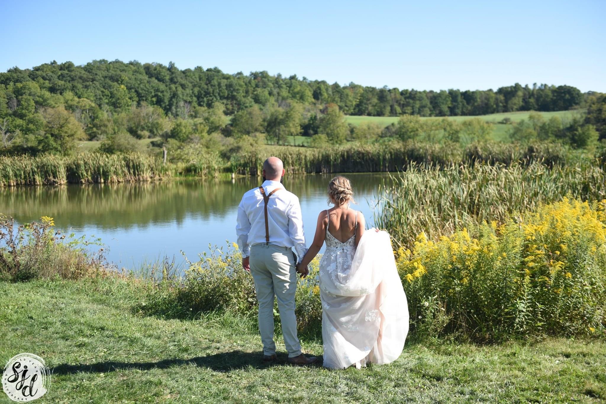 Wedding ceremony arch by the pond at 100 Springs Farm